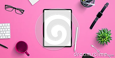 Tablet mockup on pink office, home work desk surrounded by coffee mug, plant, smart watch, glasses, keyboard Stock Photo