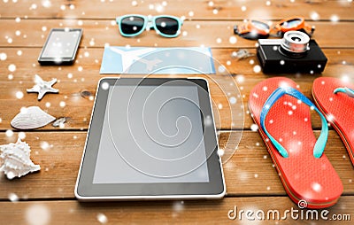 Tablet pc, airplane ticket and beach stuff Stock Photo