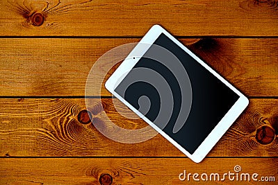 Tablet PC on natural dark wooden table, top view Stock Photo