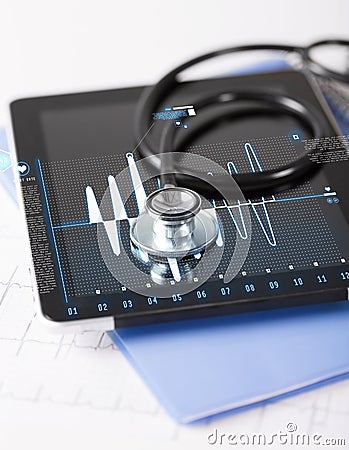 Tablet pc, stethoscope and electrocardiogram Stock Photo