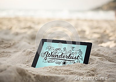 Tablet in sand with black wanderlust doodles against blue background Stock Photo