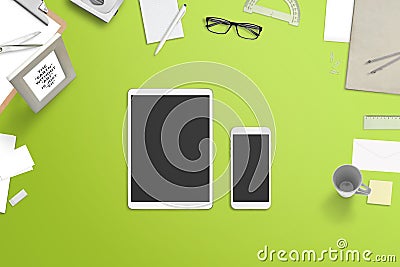 Tablet and smartphone with blank screen for mockup surrounded with stationery and office supplies Stock Photo