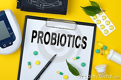 Tablet with text PROBIOTICS. Nearby is a tonometer, medicines, vitamins and a pen Stock Photo