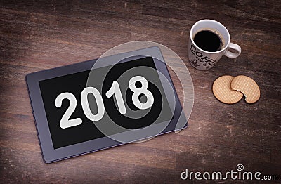 Tablet touch computer gadget on wooden table - 2018 Stock Photo