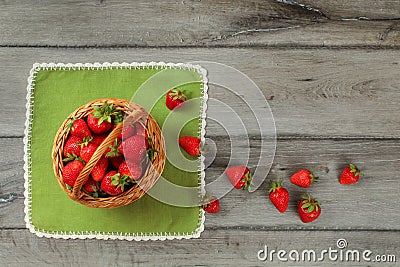 Tabletop photo, basket with strawberries , some of them spilled Stock Photo