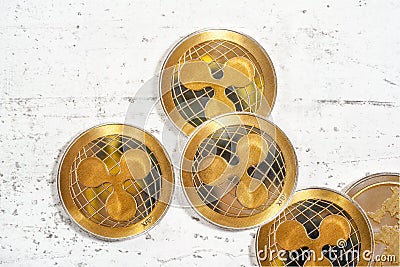 Tabletop photo - detail of golden ripple cryptocurrency coins scattered on white board Editorial Stock Photo
