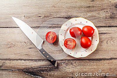 Tabletop photo of tomatoes, one of them cut Stock Photo