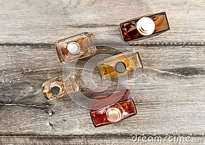 Tabletop view, men fragrances colourful bottles, on wooden boar Stock Photo