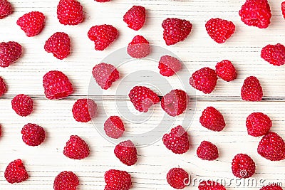 Tabletop view, raspberries spilled on white boards desk Stock Photo