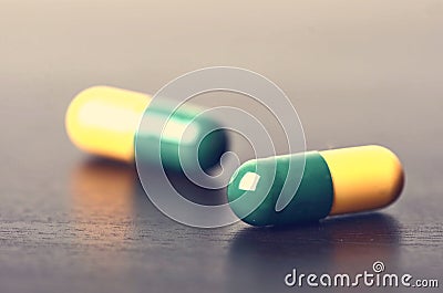Tablets on a black background. Reflection of pills on a glass. MedicineÂ´s background. Pharmacy. Close up of capsules Stock Photo