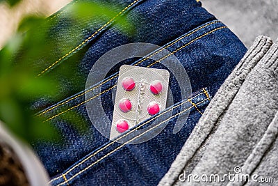 Tablets in blister in jeans pocket. The concept of antidepressants and healing Stock Photo