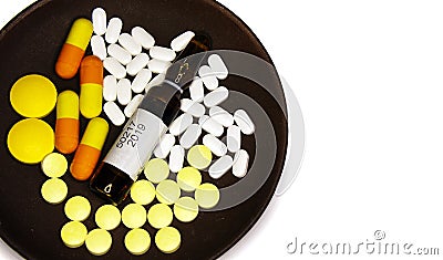 Tablets, capsules and ampoules with medicine on a plate Stock Photo