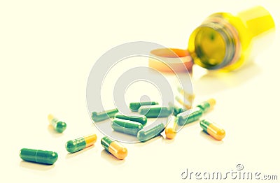 Tablets capsules pills yellow green Stock Photo