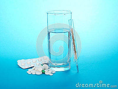 Tablets, glass with water and the mercury Stock Photo