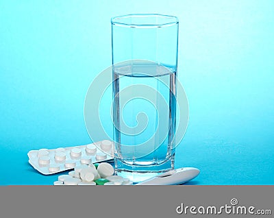 Tablets, glass with water and the thermometer Stock Photo