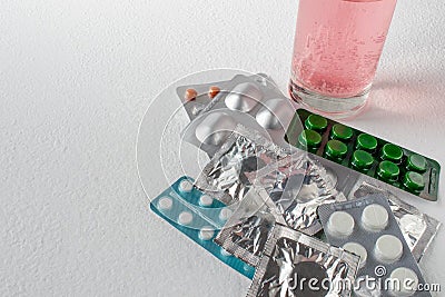 Tablets on a light background. Different types of pills. soluble tablet in a glass of water. Closed pills in pack Stock Photo