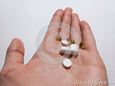 White pills are on the palm Stock Photo