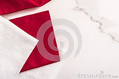 Kitchen textile on chic white marble background, napkin and towel set, folded fabrics as food styling props for luxury home decor Stock Photo
