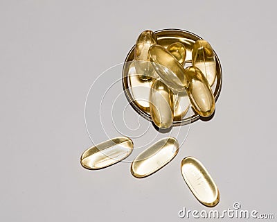 Tabs Vitamins, omega 3, Medications tablets and capsules in a beaker. Stock Photo