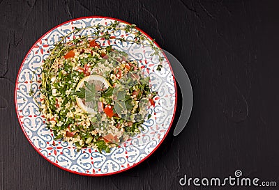 Tabule - oriental salad, appetizer on a black background copy space Stock Photo