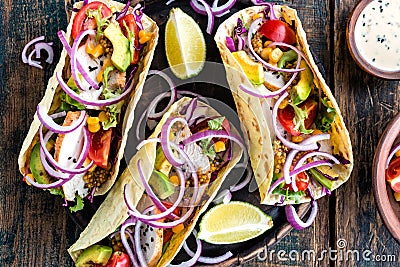Tacos with chicken meat, vegetables and fresh greens Stock Photo