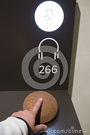 Tactile display. Blind visitor touching a neolithic pottery Editorial Stock Photo