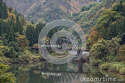 Tadami river with bridge and train Stock Photo