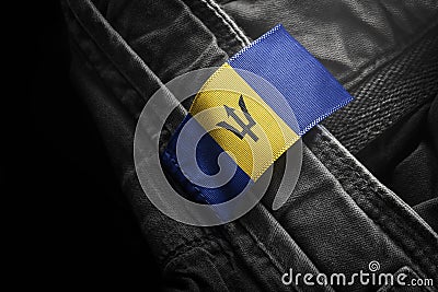 Tag on dark clothing in the form of the flag of the Barbados Stock Photo