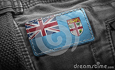 Tag on dark clothing in the form of the flag of the Fiji Stock Photo