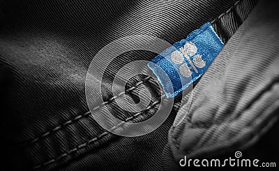 Tag on dark clothing in the form of the flag of the Organization of the Petroleum Exporting Countries Stock Photo