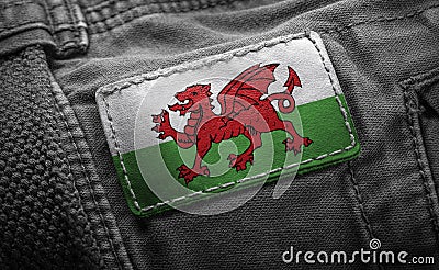 Tag on dark clothing in the form of the flag of the Wales Stock Photo