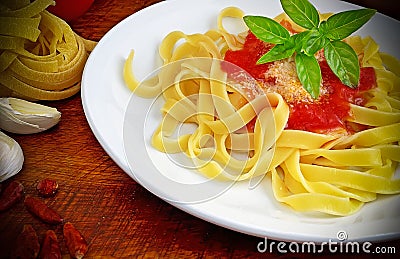 Tagliatelle, tomato and basil plate Stock Photo