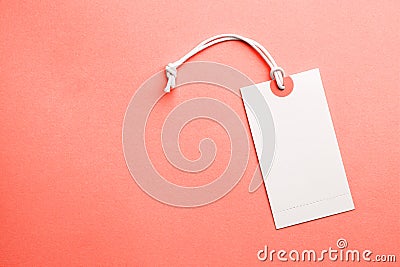 Tags for the price and labels for clothes. White tag mock-up on a orange coral background. Copy space for text Stock Photo