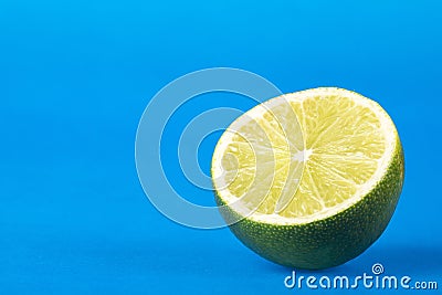 Tahiti lemon on blue background - Citrus Ã— latifolia - Text space Stock Photo