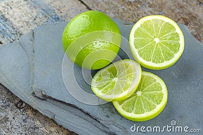 Tahitian limes on a stone . Stock Photo