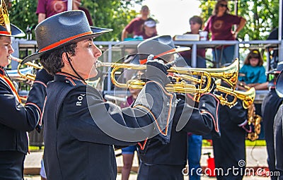 Tahlequah USA High school band members in cowboy hats and black uniforms and gloves play trumpets in front of reviewing Editorial Stock Photo