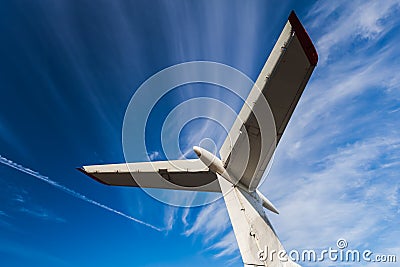 Tail of aircraft. White tail of aircraft on blue sky background. Stock Photo