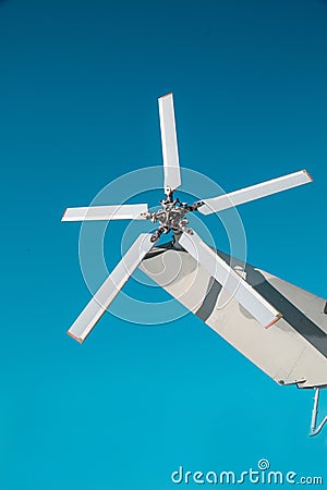 The tail rotor of the helicopter is silver against the blue sky on a clear sunny day, Military equipment atom Stock Photo