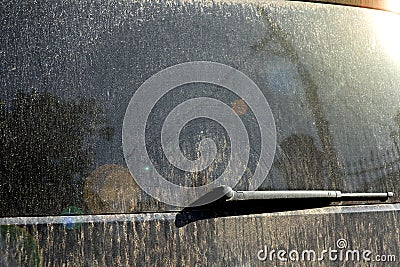 Tailgate minibus back windo with a wiper of in mud. Stock Photo