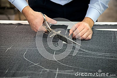 Tailor cutting fabric Stock Photo