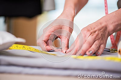 The tailor hands working on new clothing Stock Photo