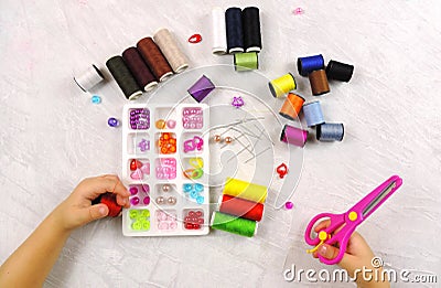 Tailor needles and threads and decorative elements, beads for children`s creativity, for embroidery, making bracelets and other j Stock Photo