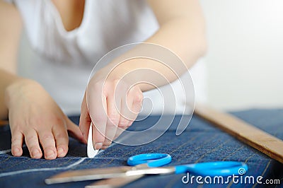 Tailoring of natural wool. Woman tailors sewing fabric. Stock Photo