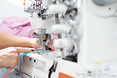 Tailoring. Sewing room, seamstress sews clothes on a sewing machine Stock Photo