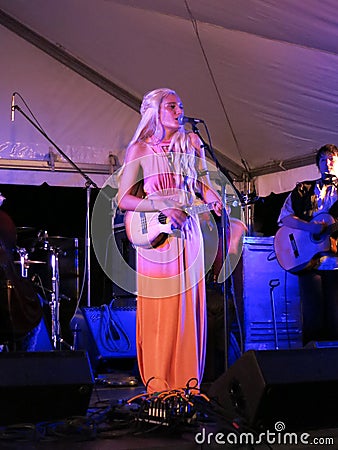 Taimane Gardner plays Ukulele and sings into mic with band Editorial Stock Photo