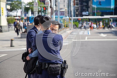 Taipei-Taiwan - DECEMBER 17TH, 2019. Angry man being arrested away by the police and put into handcuffs during a police raid Editorial Stock Photo