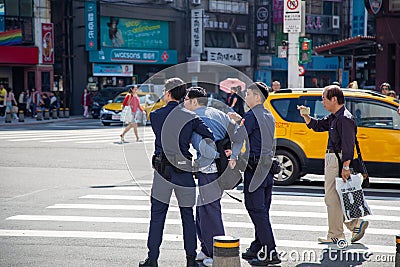 Taipei-Taiwan - DECEMBER 17TH, 2019. Unidentified man being arrested by police at ximen station exit 6, Taiwan Editorial Stock Photo