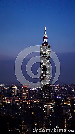 Taipei 101 tower standing in the middle of the city. A view of the tallest building in Taiwan during night time. Editorial Stock Photo