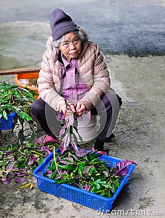 Taiwan 03/21/2018: Eldely Asian woman processes agricultural products Editorial Stock Photo