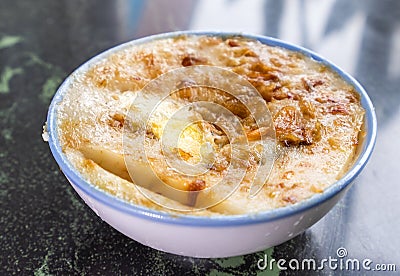 Taiwan`s distinctive famous snacks: Savory rice pudding Wa gui in a white bowl on stone table, Taiwan Delicacies Stock Photo